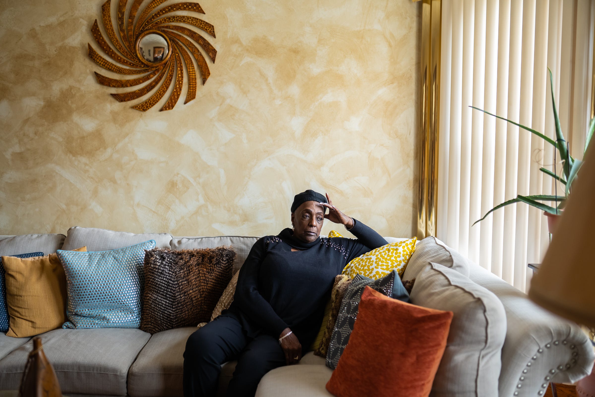 Toyia Watts, the 65-year-old president of the Charlevoix Village Association, sits on a couch at her home in Detroit's Islandview neighborhood on Monday, Feb. 17, 2020.