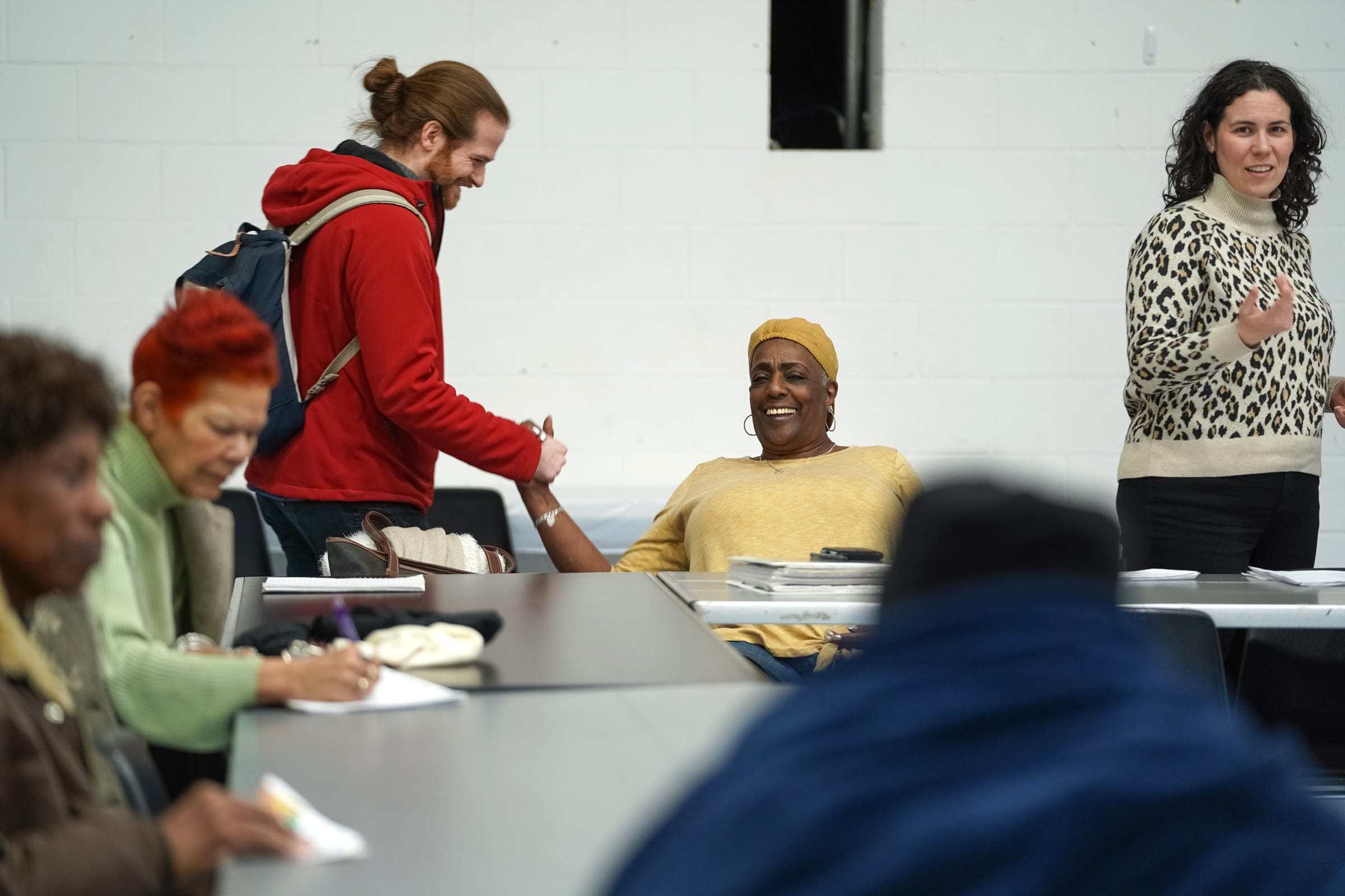 (Left to right) Charlevoix Village Association member Brian Silverstein greets CVA president Toyia Watts before the start of a neighborhood meeting at Butzel Family Center in Detroit on Tuesday, Feb. 18, 2020.