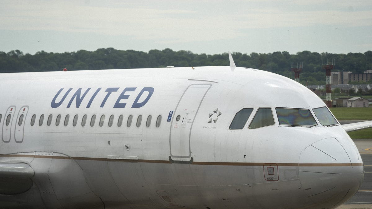 ARLINGTON, VA - MAY 05: A United Airlines plane sits at a gate Ronald Reagan Washington National Airport, May 5, 2020 in Arlington, Virginia. According to leaked internal memos, United Airlines plans to cut at least 3,400 management and administrative positions in October and potentially lay off up to 30 percent of their pilots. (Photo by Drew Angerer/Getty Images) ORG XMIT: 775509998 ORIG FILE ID: 1211897225