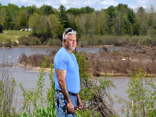 Joe Rueda, of Edenville, talks about the water level in the backyard of his girlfriend's house.