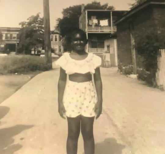 A young Rhoda Hatch stands near her home in Chicago, Ill.