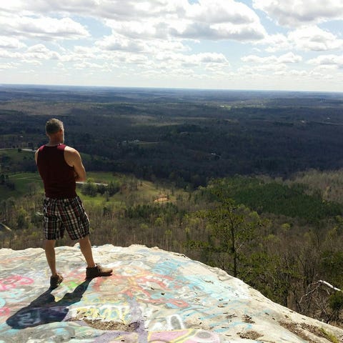 Edward Watson stands atop Currahee Mountain in nor