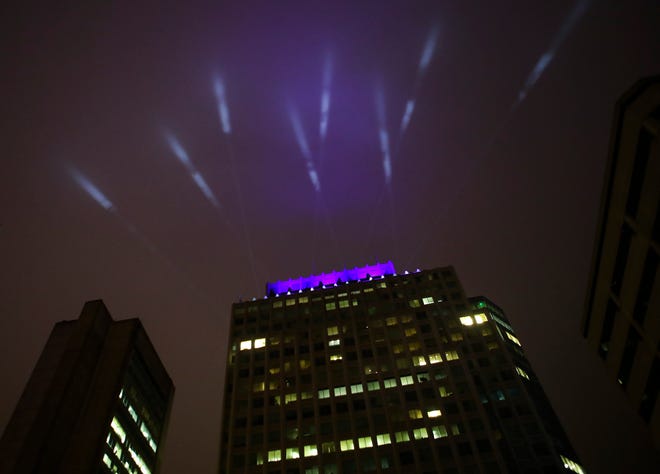 1201 N. Market is crowned with lights reaching into mist in May 2020 to honor front-line medical workers during the COVID-19 pandemic. Investor Cash Management, which received more than $4 billion in state grants Monday, has a lease at the office tower into 2023.