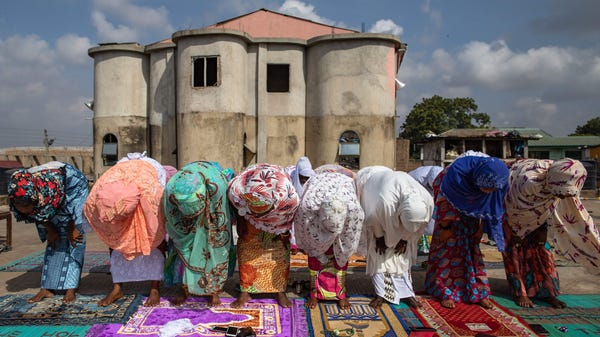 A group of Muslims women pray at a rooftop in Nima