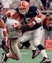 Illinois quarterback Kurt Kittner (15) is sacked by Wisconsin's Tom Burke in the first quarter Saturday, Oct. 17, 1998, in Champaign, Ill. (AP Photo/Frank Polich).