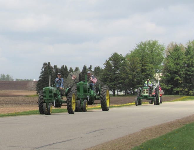 The stars and stripes lends a patriotic feel to these John Deere tractors that were a part of the impromptu tractor parade on the rural byways of Seymour, Wis.