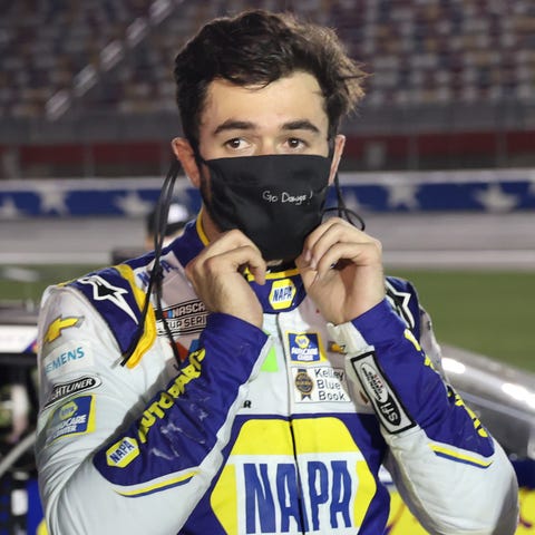 A disappointed Chase Elliott stands on the grid af