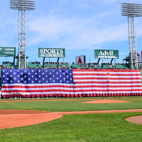 An American flag is unfurled over the Green Monste
