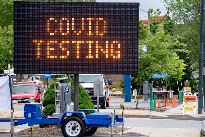 Medical and emergency response officials set up a Buncombe County COVID-19 testing site on Coxe Avenue downtown on May 26, 2020. 
