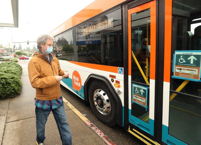 Dennis Harman prepares to board the bus at the Kitsap Transit Bus Stop in front of the R & H Market on Kitsap Way in Bremerton in May 2020.