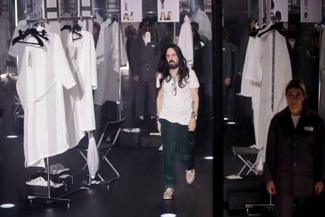 Designer Alessandro Michele walks out at the end of Gucci's Fall/Winter 2020/2021 collection on Feb. 19, 2020. Gucci and St. Laurent are two of the highest profile luxury fashion houses to announce they will leave the fashion calendar behind, with its relentless four-times-a-year rhythm, shuttling cadres of fashionistas between global capitals where they squeeze shoulder-to-shoulder around runways for 15 breathless minutes.