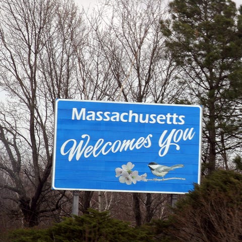 A road sign welcoming drivers to the state of Mass