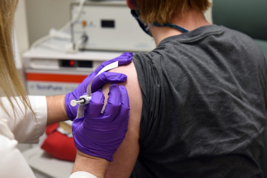 The first patient enrolled in Pfizer's COVID-19 vaccine clinical trial at the University of Maryland School of Medicine in Baltimore receives an injection May 4.