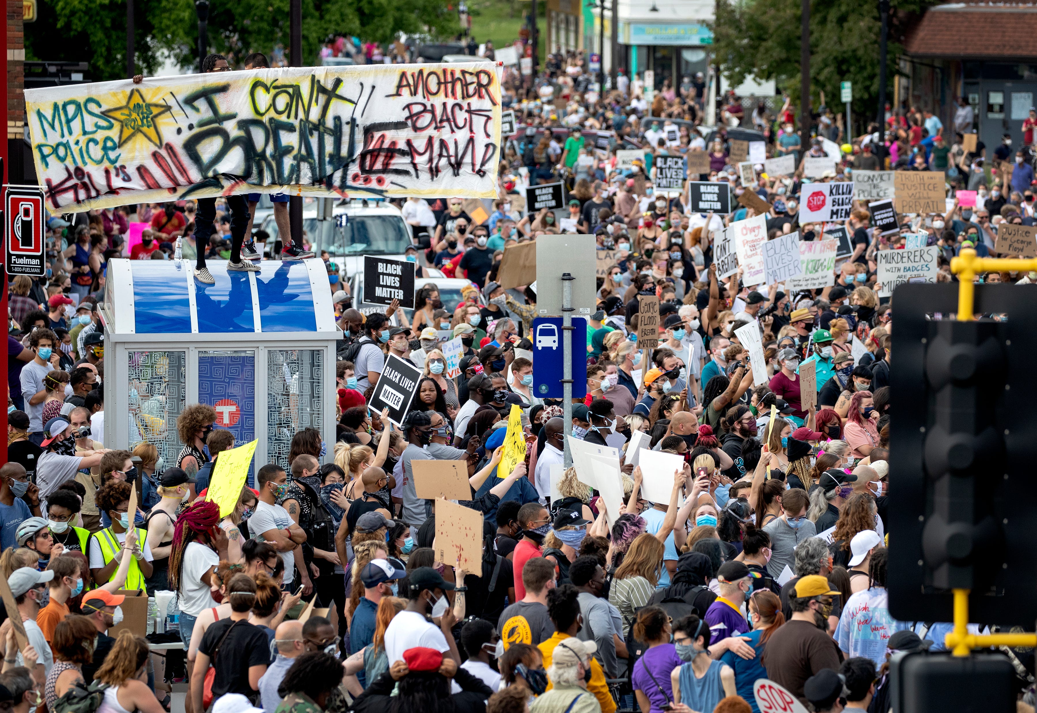 Protesters gather calling for justice for George Floyd on Tuesday, May 26, 2020, in Minneapolis. Four Minneapolis officers involved in the arrest of Floyd, a black man who died in police custody, were fired Tuesday, hours after a bystander's video showed an officer kneeling on the handcuffed man's neck, even after he pleaded that he could not breathe and stopped moving.