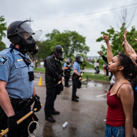 Protesters and police face each other during a ral