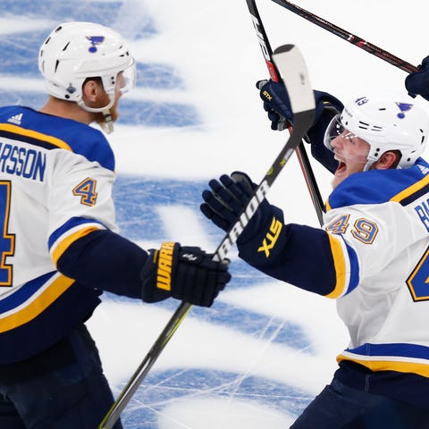 St. Louis Blues players celebrate an overtime game