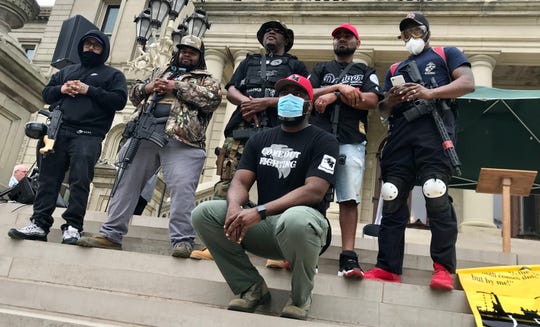 Armed participants in a demonstration at the Michigan Capitol on Thursday, May 28, 2020, pose for a photograph.