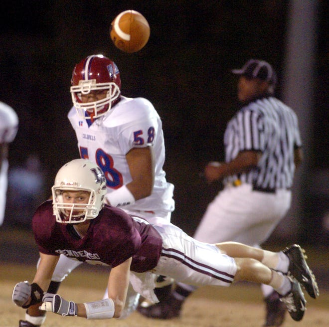 Henderson County's John Nord (13) glides to the ground as he misses the throw by Will Fidler during the 2005 playoff game against Christian County.