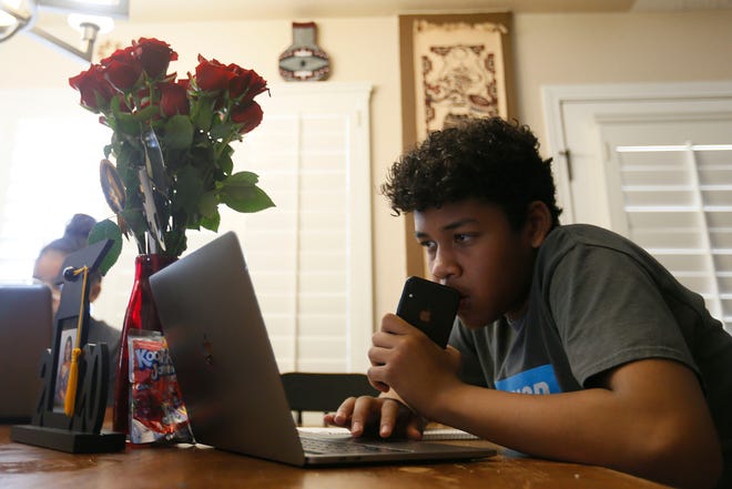 Coby Ray, a seventh-grader at Col. John O. Ensor Middle School, finishes up his curriculum for the end of the school year Tuesday, May 26, 2020, at his home in El Paso.