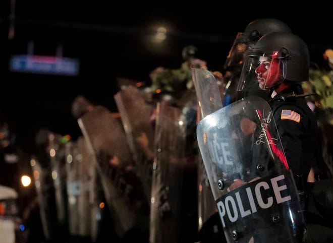 A Memphis police officer looks out into the crowd during a protest over the death of George Floyd in May 2020.