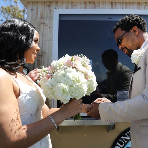 Rodney and Monica Cosby exchange rings as they tak