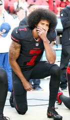 Colin Kaepernick kneels during the national anthem in a 2016 game against the Arizona Cardinals.
