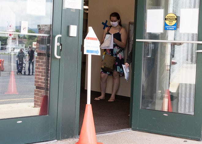 BMV customers must stand outside in the hallway as they are forced to social distance to help deter the increasing numbers of those getting sick from the coronavirus on May 28, 2020.