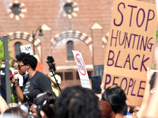 Victoria Burton-Harris, of Grosse Pointe, a candidate for Wayne County prosecutor, talks on the mic.