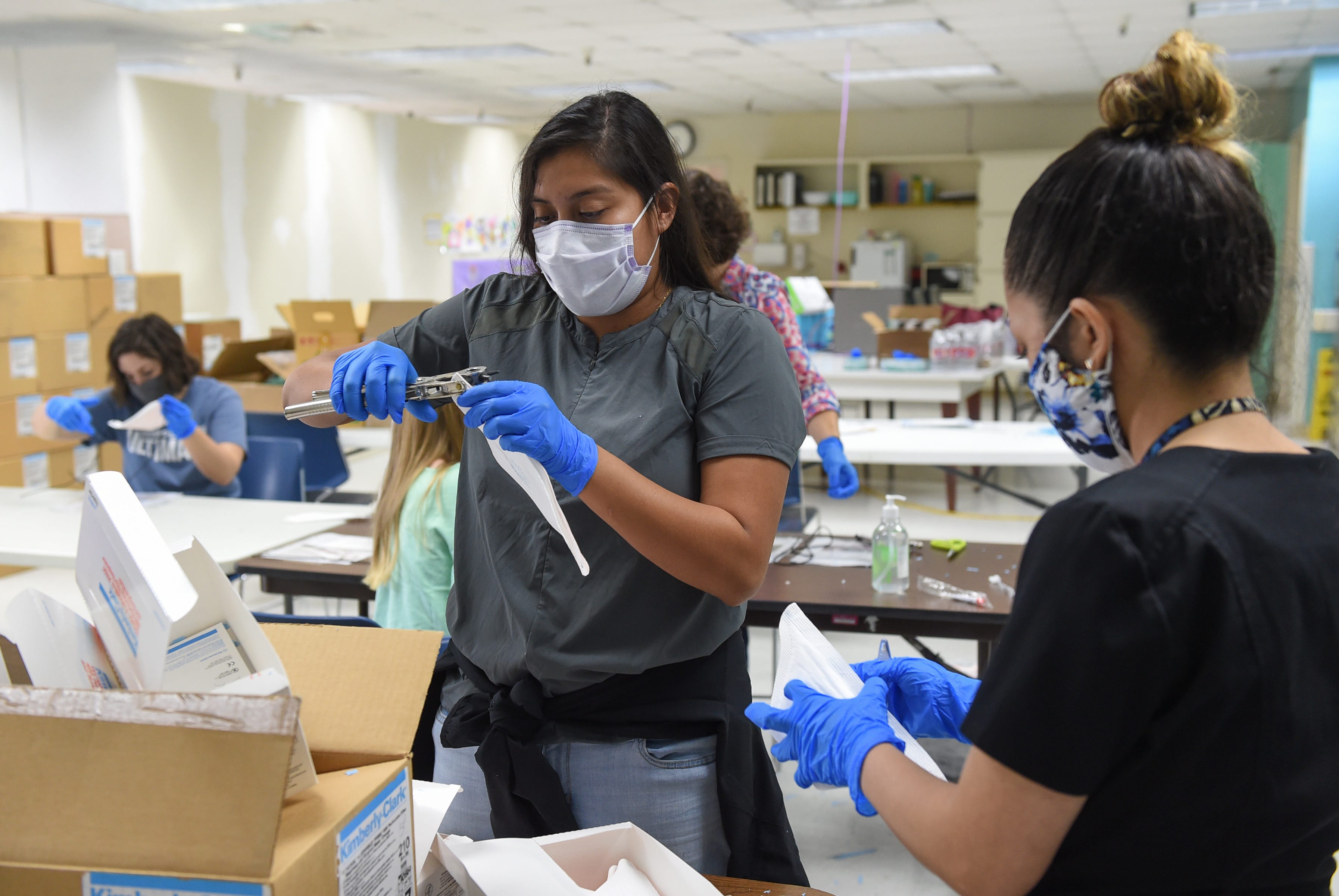 Volunteers for PPE for Guam help to repair 5,000 N95 masks from the U.S. Strategic National Stockpile at Guam Memorial Hospital in this May 30, 2020, file photo.
