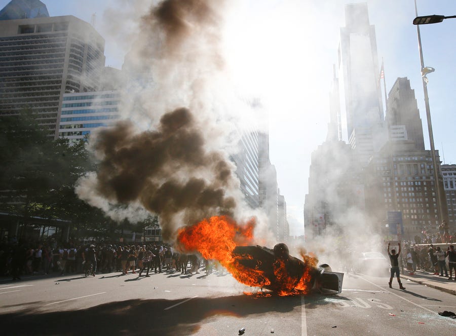 Smoke rises from a fire on a police cruiser in Center City during the Justice for George Floyd Philadelphia Protest on Saturday, May 30, 2020, in Philadelphia.