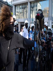 Police officers use bicycles to push back a crowd of demonstrators Saturday in Philadelphia.