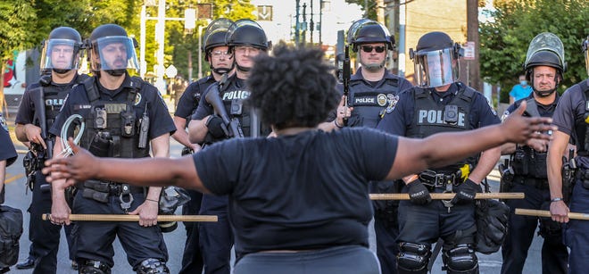 A crowd gathers on Bardstown Road in the Highlands to protest the killing of Breonna Taylor on May 30, 2020 in Louisville, Ky.  Police in riot gear block them from moving further south on Bardstown Road.