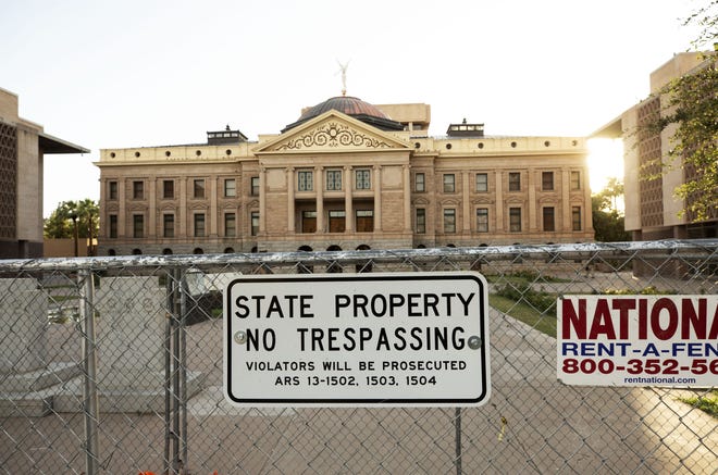 Fencing surrounds the Arizona state Capitol to protect it from protesters on May 30, 2020.