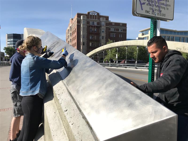 Edgar Gonzalez of Sparks cleans graffiti off the Virginia Street bridge May 31, 2020, the day after protests downtown turned violent and caused significant damage to the area.