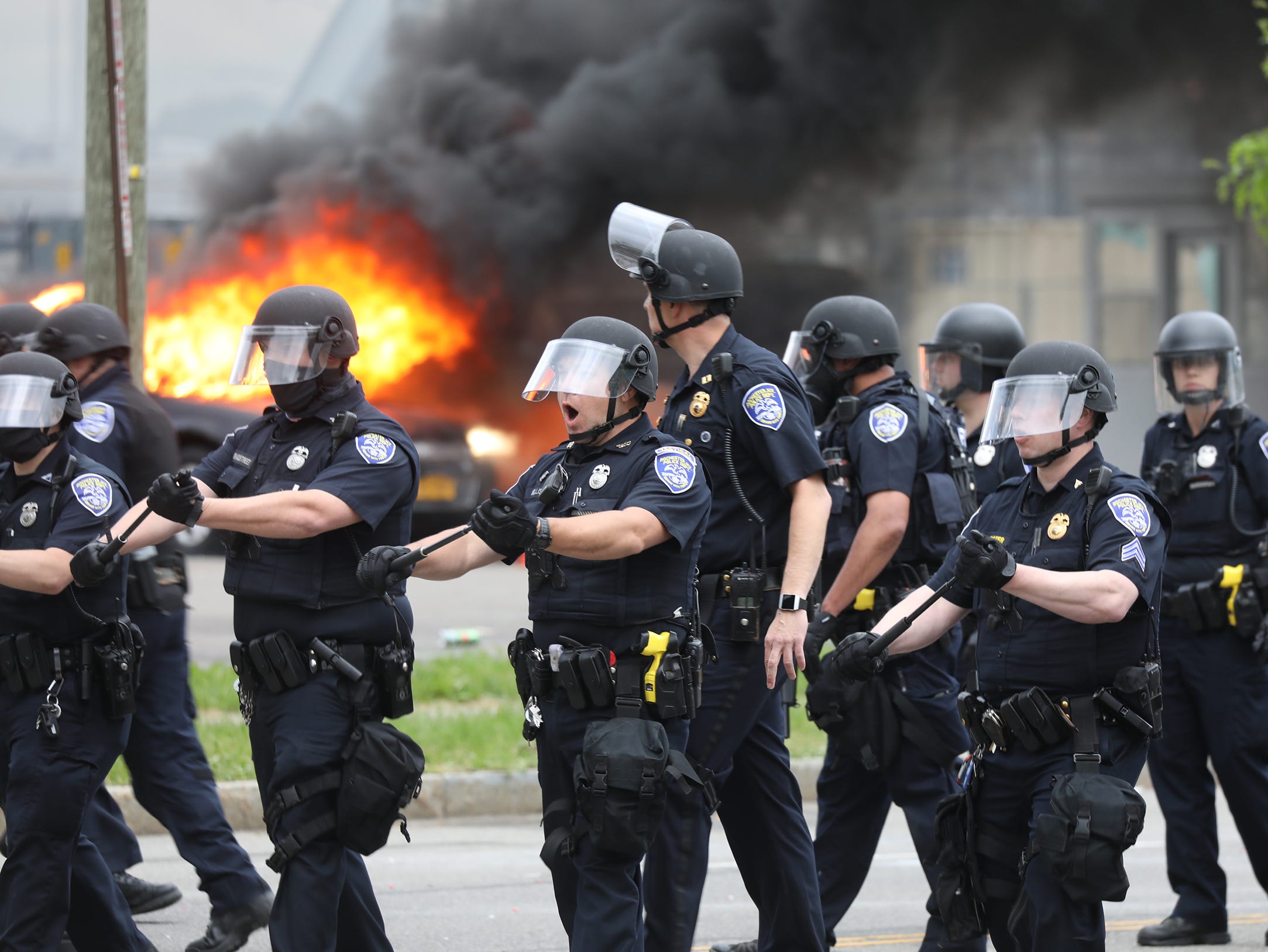 After a Black Lives Matter rally ended in downtown Rochester some protesters destroyed police cars and destroyed cars in a parking lot across from the Public Safety Building on Saturday, May 30, 2020. Cops chanted move back while moving people towards Broad and Exchange.
