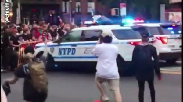 During a protest in New York, an NYPD SUV can be s