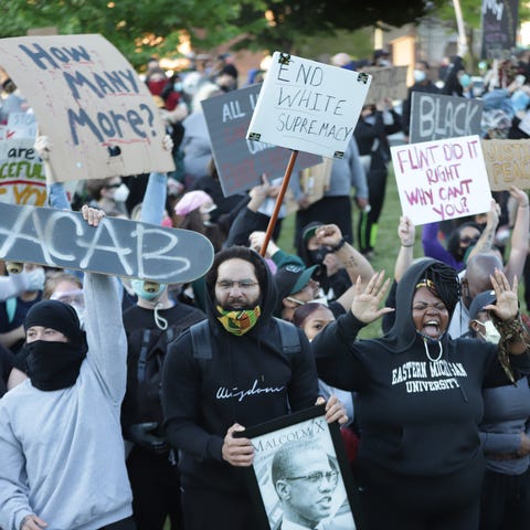 Demonstrators march through downtown Detroit in pr