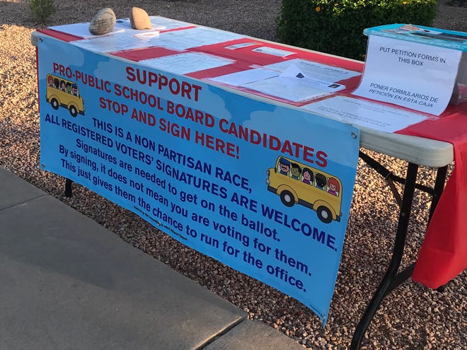 Tempe Elementary candidate Allison Ewers placed a table outside her house for neighbors to sign petitions, which she quarantines in a plastic box outside for 72 hours.