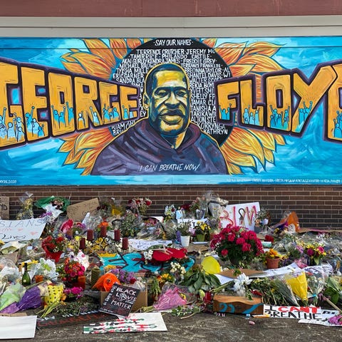 A makeshift memorial for George Floyd includes mur