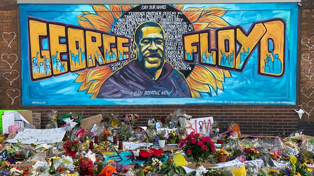 A makeshift memorial for George Floyd includes mural cards and flowers near the spot where he died while in police custody in Minneapolis.