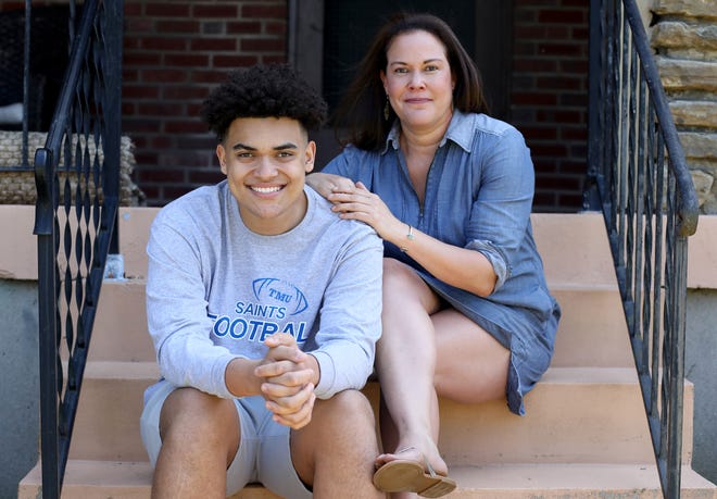 Owen Smith, left, sits for a portrait with his mother, Andrea Johnson, at their home, Tuesday, June 2, 2020, in Cincinnati. 