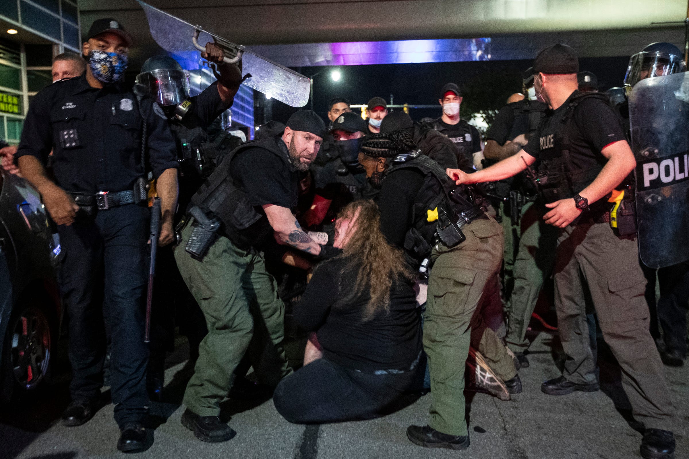 A protester is being arrested by the Detroit police officers on Randolph Street in downtown Detroit, Friday, May 29, 2020.