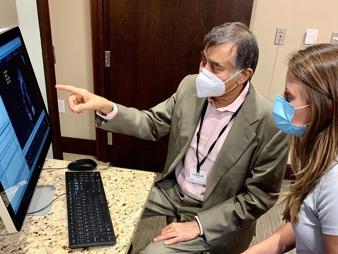 from left: Bijoy K. Khandheria, medical director for the echocardiogram lab at Aurora St. Luke's, works with sonographer Abigail Kaminski reviewing a heart ultrasound scan.