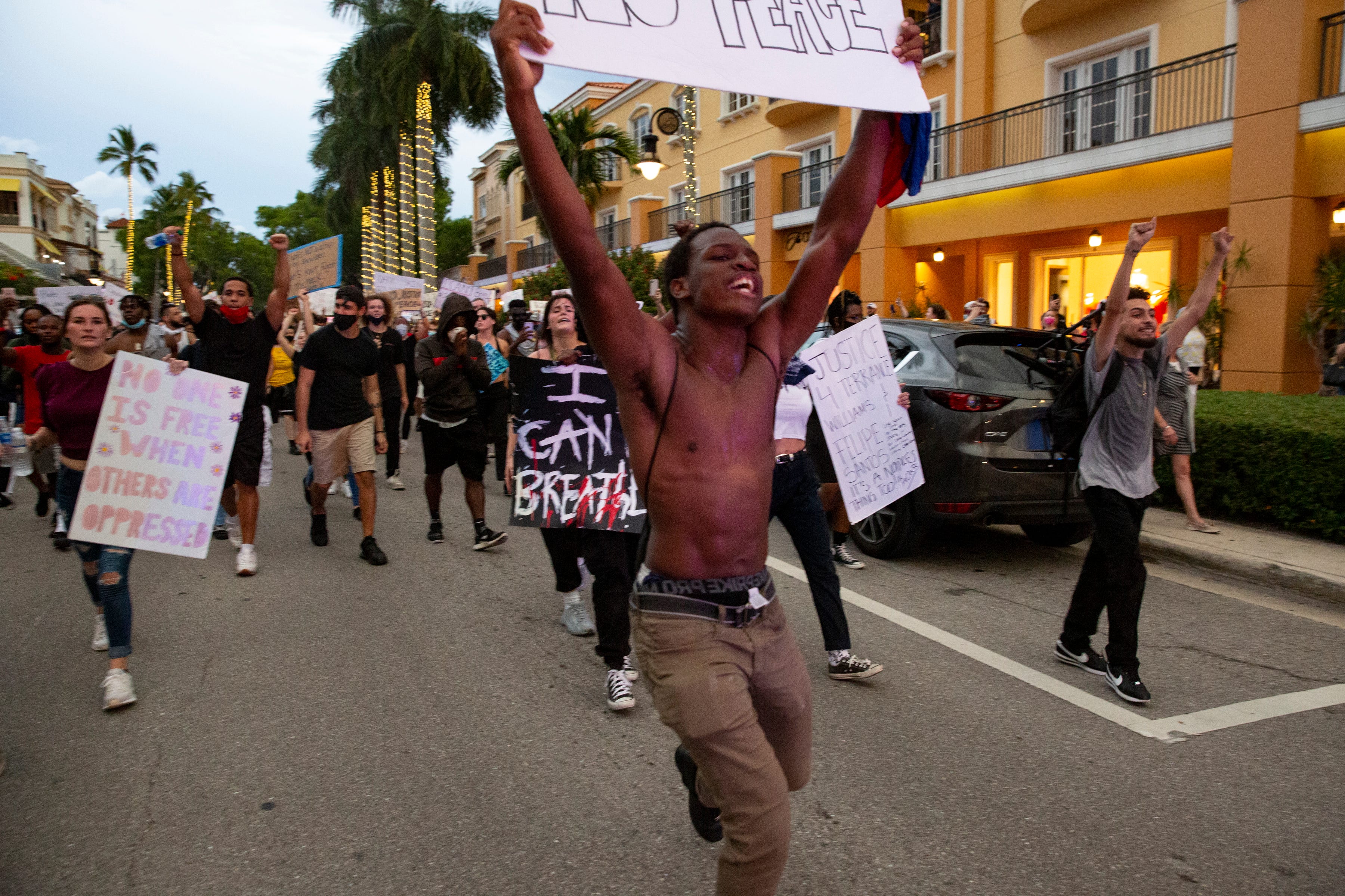 Protesters make their way down Naples' 5th Avenue South on Monday, June 1, 2020.