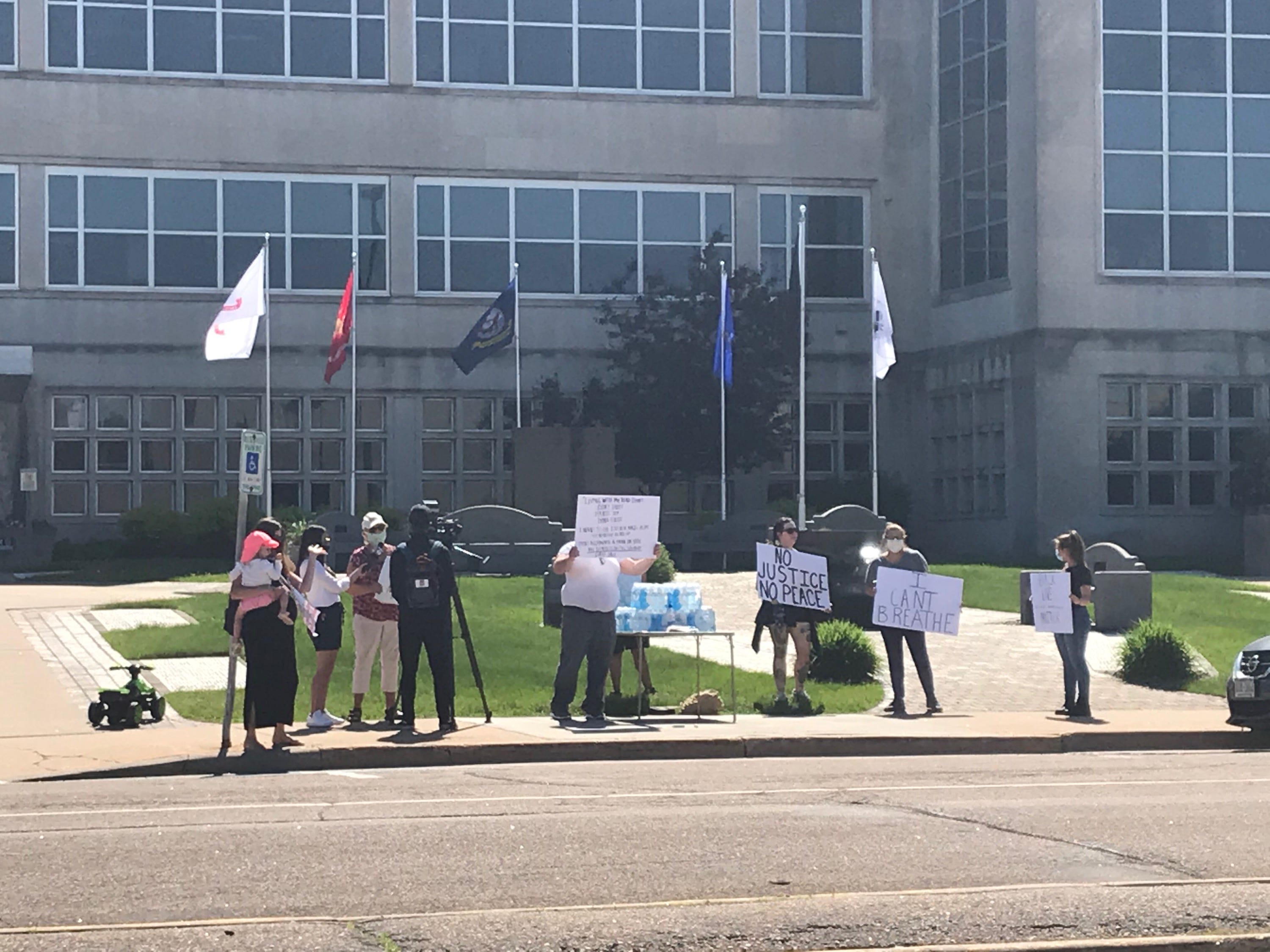 About a dozen people gather in front of the Wood County Courthouse in Wisconsin Rapids Tuesday morning as part of the #JusticeForFloyd Peaceful Protest. The event was scheduled from 10 a.m. to 6 p.m.