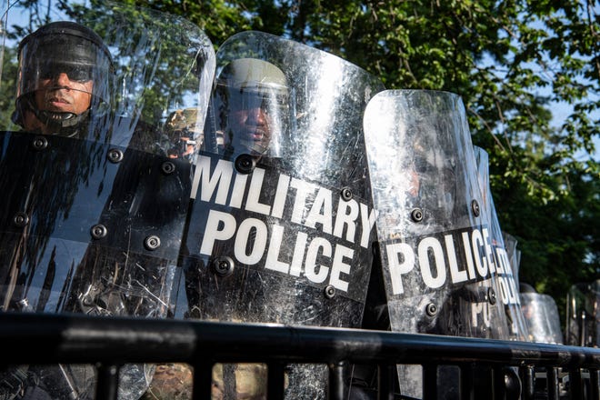 A cadre of law enforcement including Park Police, Metro Police Department and D.C. National Guard face-off with protesters across barriers in Lafayette Square just in front of the White House in Washington, D.C., on June 1, 2020.
