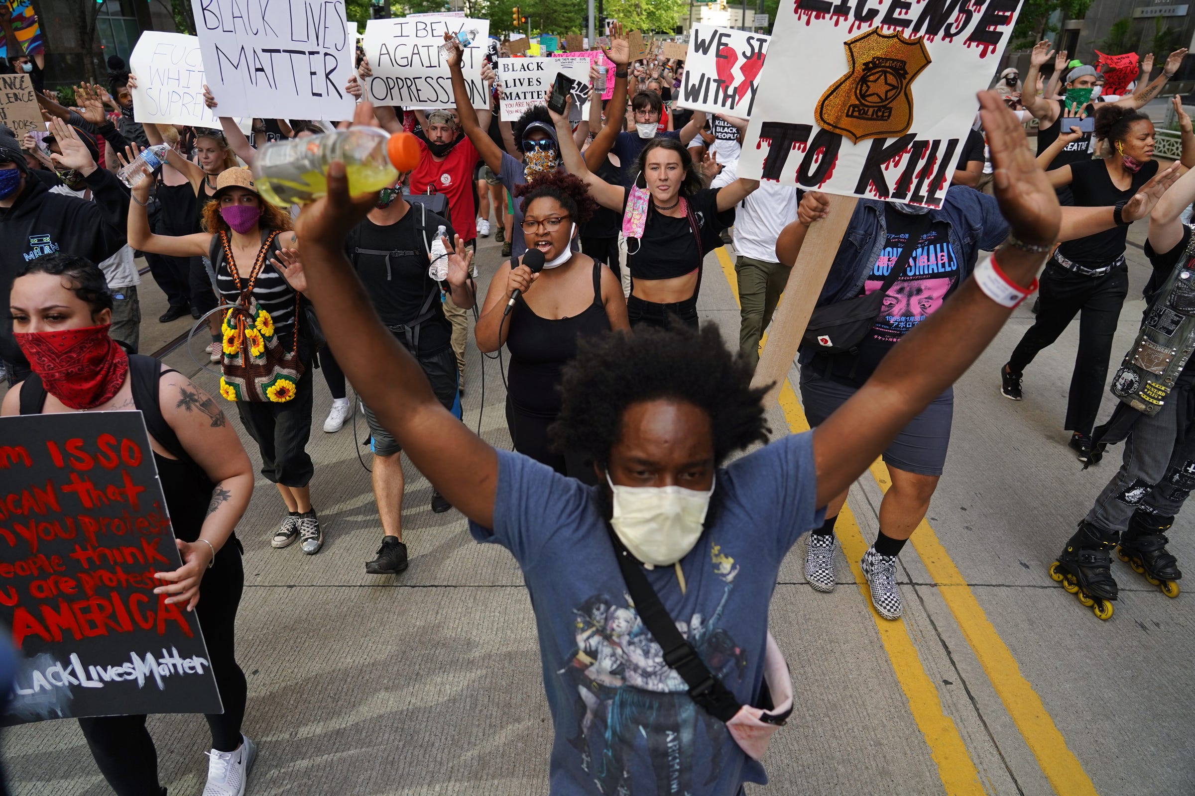 Tristan Taylor of Detroit leads a group of protesters along Woodward Avenue during the sixth day of protests against police brutality on Wednesday, June 3, 2020.