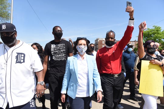 Lt. Gov. Garlin Gilchrist II, middle left, and Gov. Gretchen Whitmer attend a march against police brutality in Highland Park on June 4.