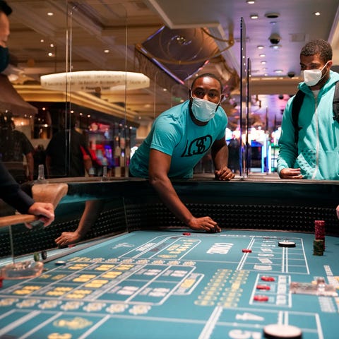 People play craps after the reopening of the Bella