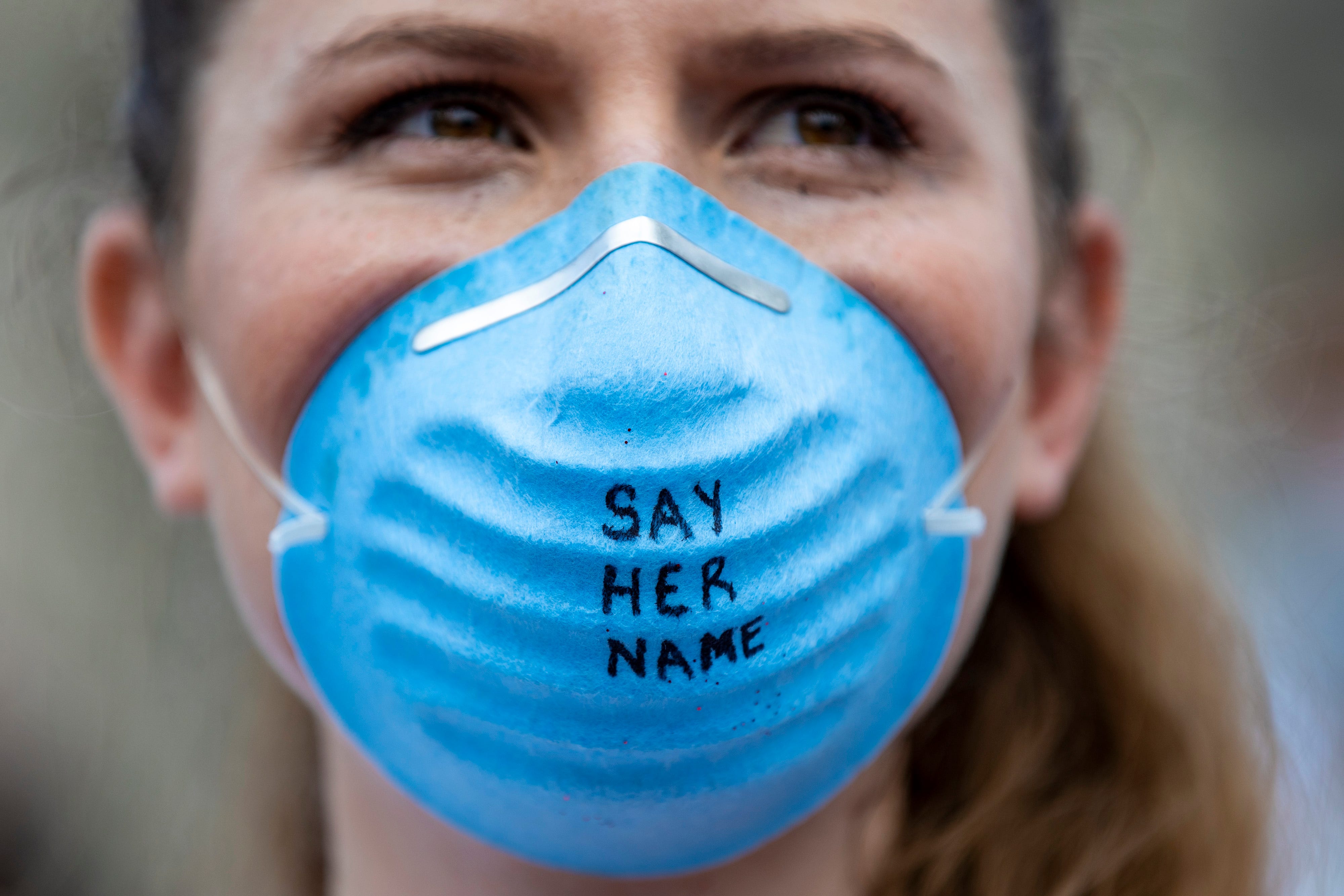 Lura Frye, a U of L medical student, wears a mask that says "say her name" in Jefferson Square Park on what would have been Breonna Taylor's 27th birthday. June 5, 2020